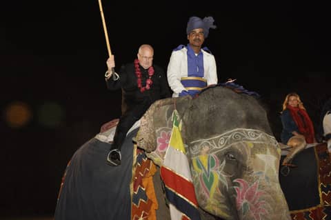 Night: guest riding a painted, decorated elephant with mahout