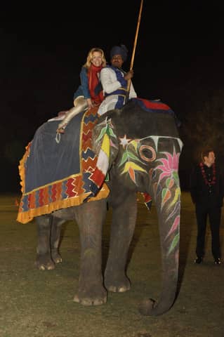 Two people on a painted elephant (portrait framing)