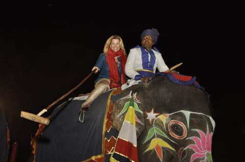 Gayle and mahout on painted elephant, close