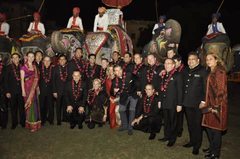 Same large group in front of elephants, clean frame