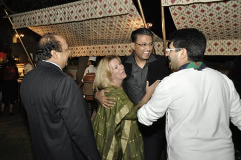 Guests greeting each other under a tent canopy