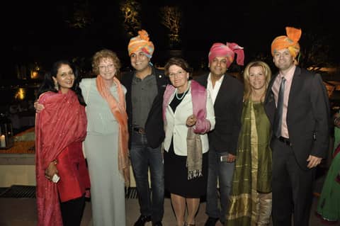 Group of eight in turbans and stoles at night