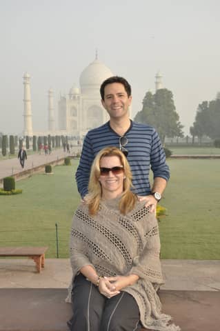 Taj Mahal: man standing behind seated woman in shawl (portrait framing)
