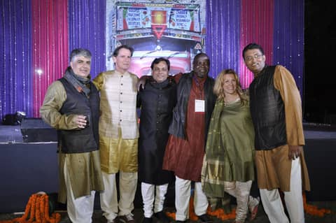 Six in Indian dress posing on stage, Gayle in green
