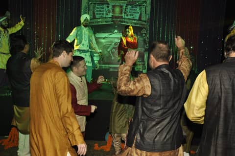Men dancing on stage, arms up