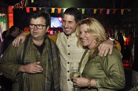 Three: two men and Gayle in green, smiling