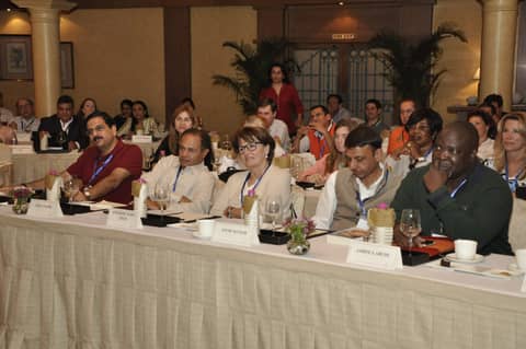 Classmates seated at session tables