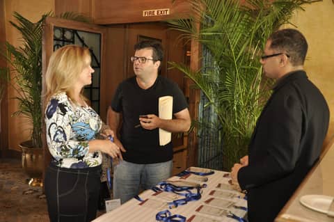 Gayle and two men by a registration table
