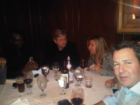 Restaurant dinner: four at a table, man in front close
