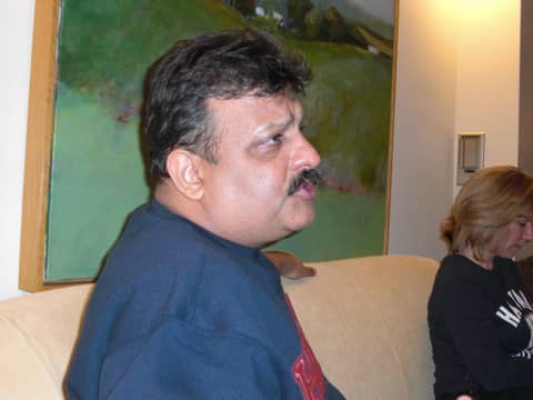 Man in profile on sofa, woman behind