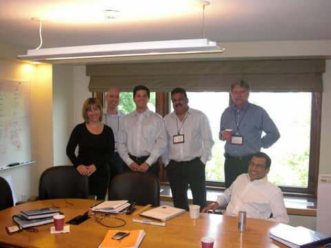 Meeting room: five standing behind table